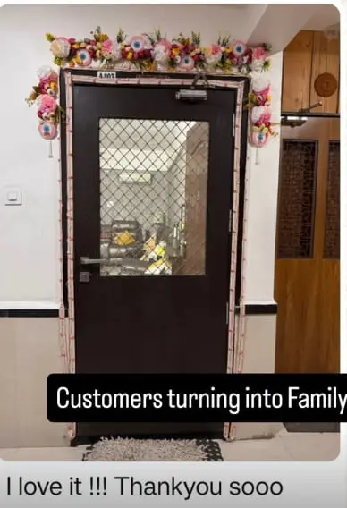 Customer photo of the floral toran on their front door, with the message: I love it, thank you so much
